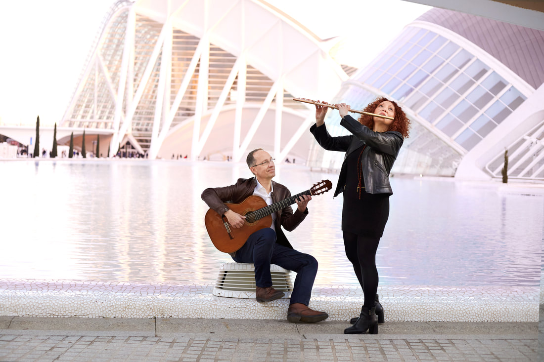 Cavatina Duo photographed together, the flutist holding her flute and the guitarist his classical guitar