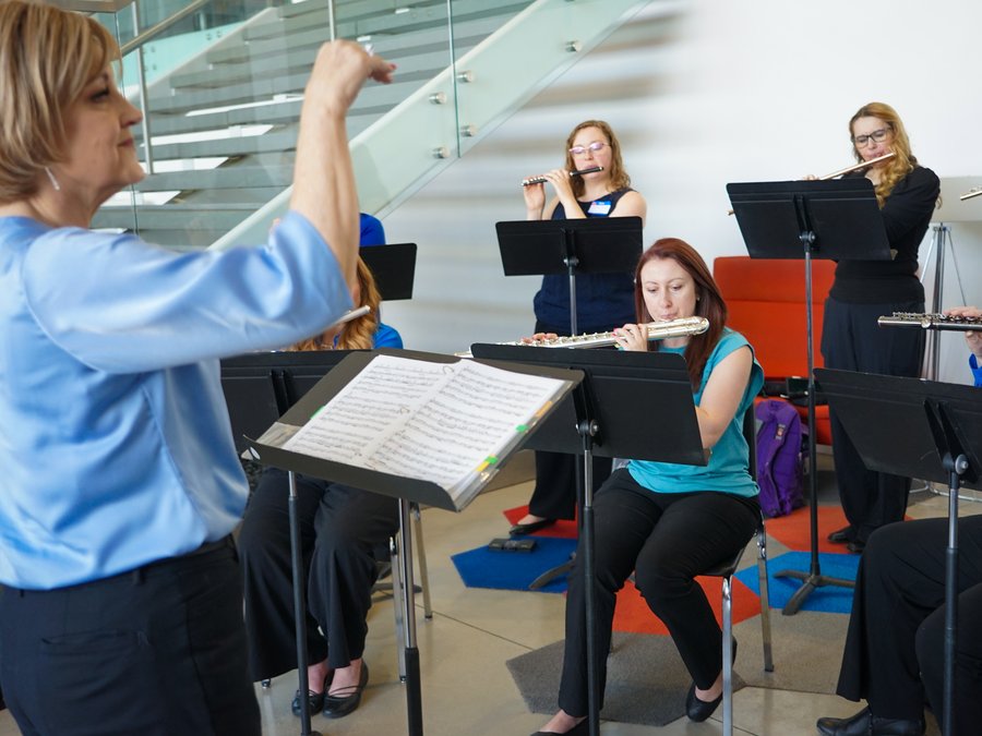 A conductor leading a UFA flute ensemble rehearsal