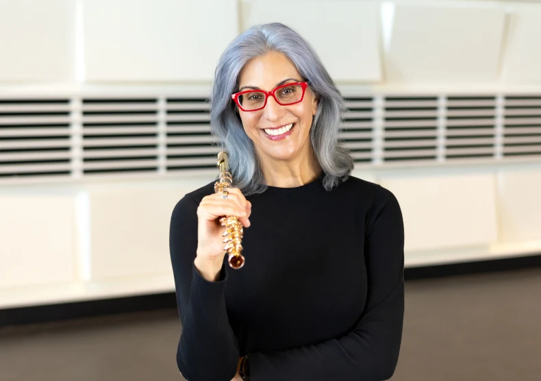 Guest artist Marianne Gedigian holding a flute headjoint and smiling